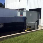 4075_KirbyRisk_EM-40W_2 Auger-Pak™ EM-60W, Open at the Dock, Rear Feed Flip Hopper, Forklift and Hand-fed, with Attached Container, Outside View