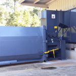 Dual-Shaft Hydrostatic Shear Shredder, Auger-Pak EM-15G with attached receiving container.